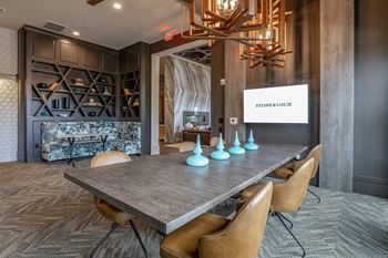 A conference room with a stone wall and a sign that says StoneLoch.